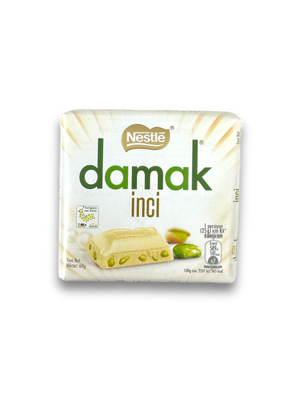 Nestle Damak White Choc 60g Vorderseite weiße Verpackung mit grüner Schrift auf weißem Hintergrund 