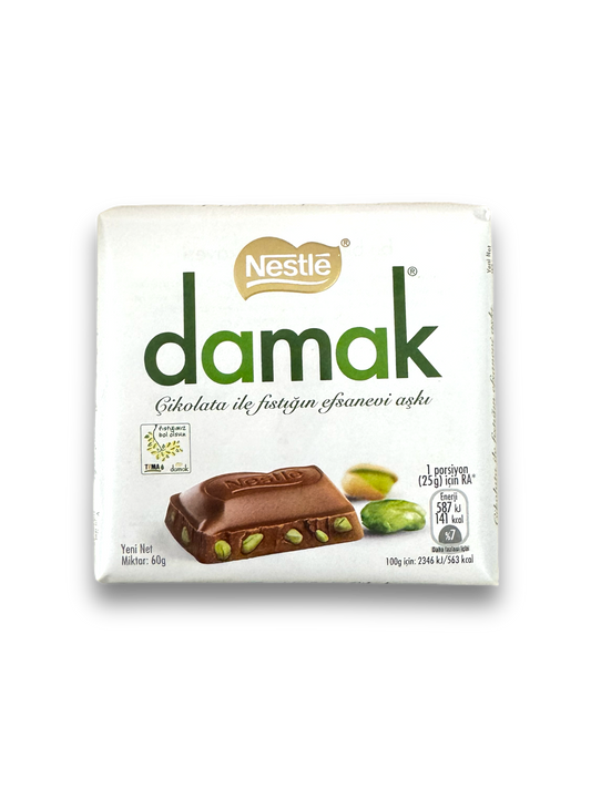 Nestle Damak Milk Chocolate Pistazie 60g Vorderseite weiße Verpackung mit grüner Schrift